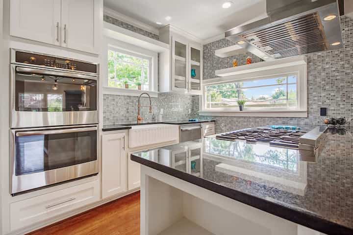 An image of a modern kitchen with sleek appliances, featuring a gas stove, refrigerator, and built-in microwave in Bohemia